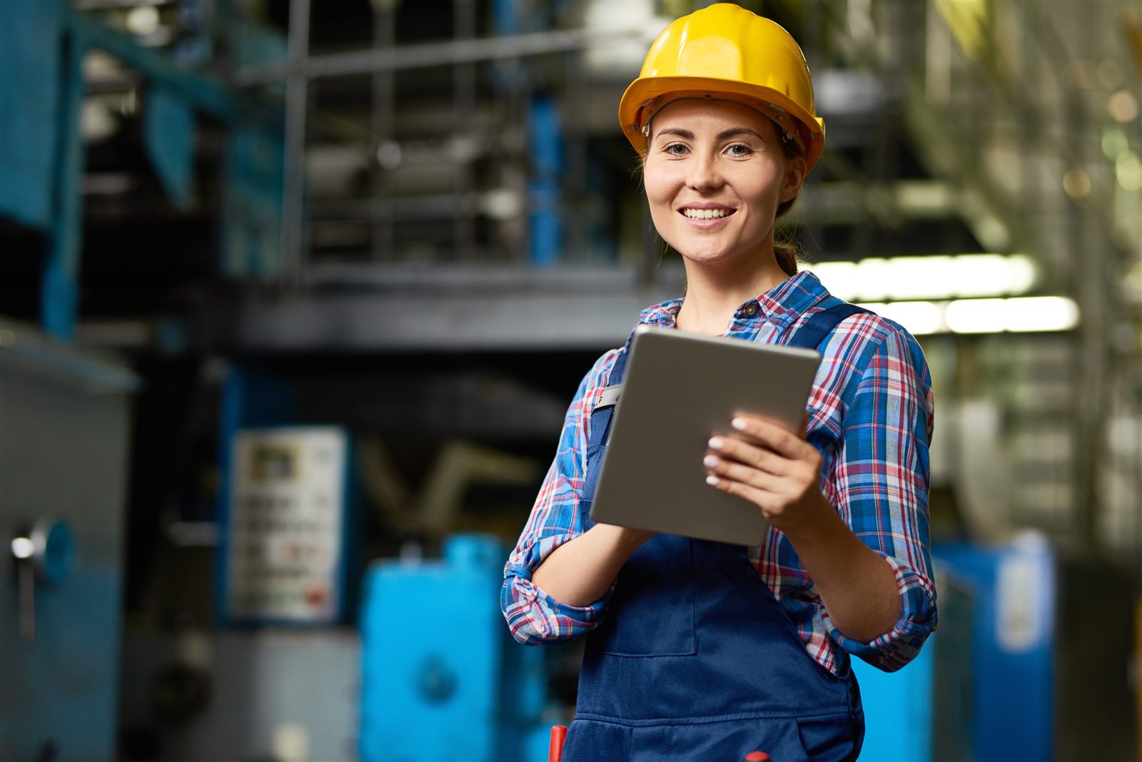 Engineer reviewing vibration data on tablet in factory